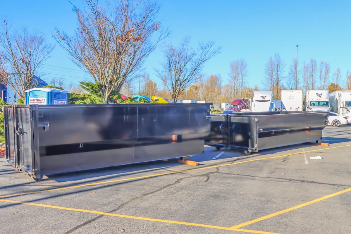 Professional dumpster rental service with roll-off container on residential driveway in Stayton